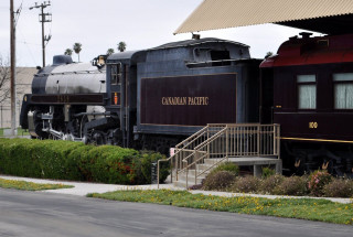 Train parked building sidewalk bench - a walkway free wallpaper