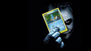 Man holding joker card batman - a card free wallpaper