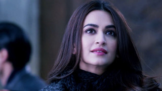 Woman long hair black coat 2 - a man in the background free wallpaper