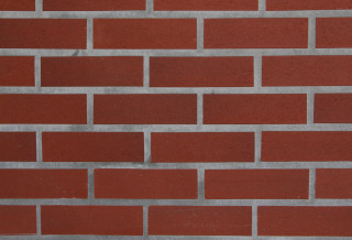 Red brick wall white clock 4 - a red brick wall behind free wallpaper
