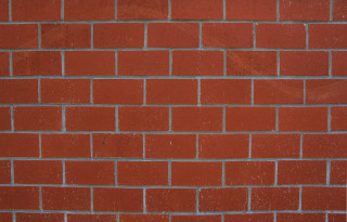 Red brick wall white clock 5 - a red brick wall behind free wallpaper