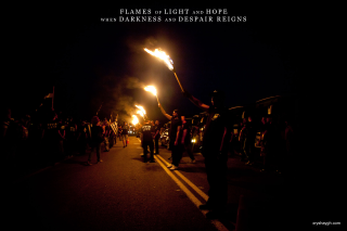 Torches dark flames light hope - a quote above them free wallpaper