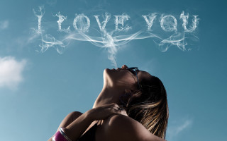 Woman blowing smoke i love - the sky behind her free wallpaper