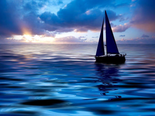 Sailboat ocean sunset dawn clouds - a sailboat free wallpaper