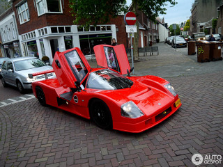 Red sports car brick road - the front of it free wallpaper