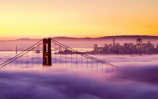 Foggy bridge sunset city distance - a city in the distance free wallpaper