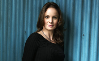 Woman black top blue background - free portrait wallpaper for desktop