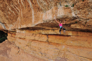 Woman climbing cliff rock face - amy weber free wallpaper