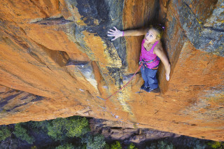 Woman climbing cliff arms out - claire falkenstein free wallpaper