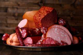 Plate of meats and vegetables - a wooden wall behind free wallpaper for desktop