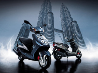 Motorcycles parked tall building spire - two motorcycle free wallpaper