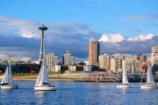 Sailboats city skyline tall buildings - the water near a city skyline free wallpaper