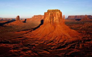 Large rock formation desert sky 3 - a large rock formation in the middle of a desert area free wallpaper