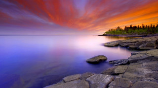 Sunset lake rocks trees beautiful - a beautiful sunset over a lake free wallpaper