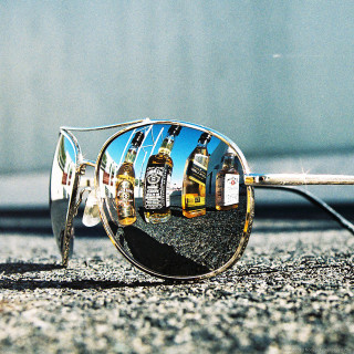 Sunglasses reflection yellow bus image - a still life free wallpaper for tablet