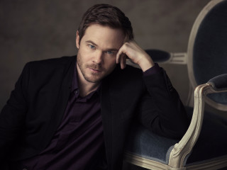 Man sitting chair hand on - a chair in the background free wallpaper