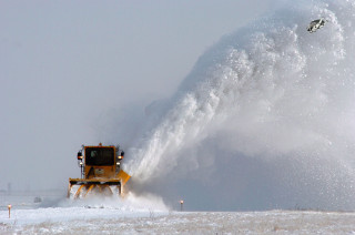Snow blower spraying snow field - photograph free wallpaper for desktop