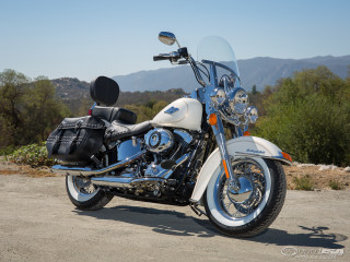 Motorcycle parked road mountains background - a clear sky free wallpaper