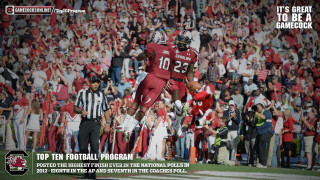 Football player jumping air ball - his hand and a crowd free wallpaper