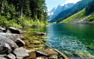 Mountain lake trees rocks background 2 - a clear blue sky free wallpaper for desktop