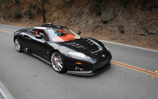 Black sports car cliff road - a black sports car free wallpaper