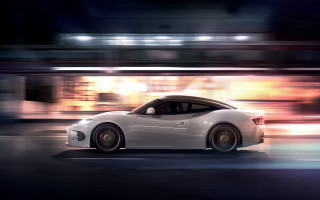 White sports car night motion - a cityscape in the background free wallpaper for desktop