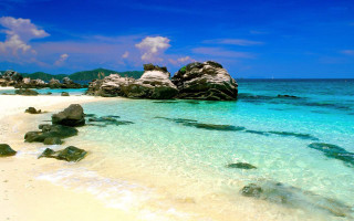 Beach rock formation blue sky - a rock formation free wallpaper