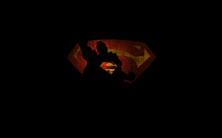 Superman logo dark red light - a silhouette of a man free wallpaper