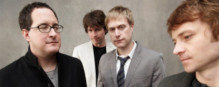 Group men wall gray background - a black jacket free wallpaper