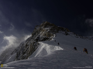 Climbing snow mountain dark sky - a dark sky in the background free wallpaper