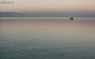 Boat out on water at - hazy free wallpaper