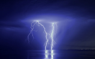 Lightning strikes water night dark - over a body of water free wallpaper for desktop
