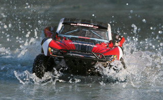 Red white fourwheeler driving water - tire free wallpaper