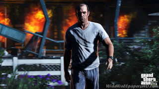Man walking fire knife house - fire in the background free wallpaper