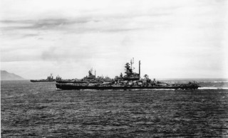 Large ship ocean small ship 2 - a mountain in the distance free wallpaper