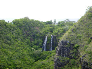 Waterfall lush forest sky people - a waterfall in the middle free wallpaper