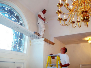 Two men painting window chandelier - an art deco painting free wallpaper
