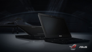 Laptops table darkroom person background - a person in the background free wallpaper