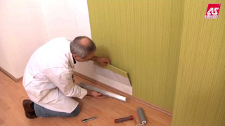 Man kneeling tools wallpapered wall - blunt border free wallpaper