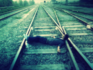 Man laying train tracks head - daarken free wallpaper