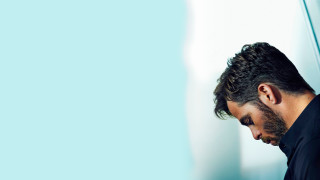 Bearded man black shirt leaning - his cell phone free wallpaper