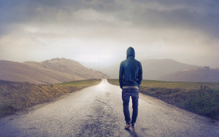 Man walking road mountain range - a mountain range in the distance free wallpaper