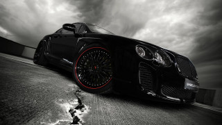 Black car red rims cloudy - black background free wallpaper
