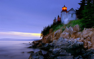 Lighthouse rocky cliff dusk water - a rocky cliff free wallpaper
