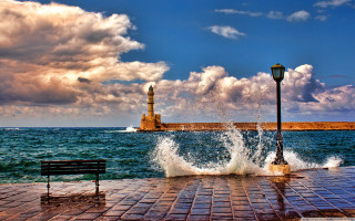 Lighthouse ocean bench brickwalkway stormy - a lighthouse in the background free wallpaper