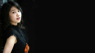 Woman blackhair blueeyes gothic portrait - a black background behind her free wallpaper