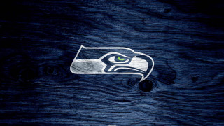 Seattle football logo green eye - a wooden surface free wallpaper for desktop