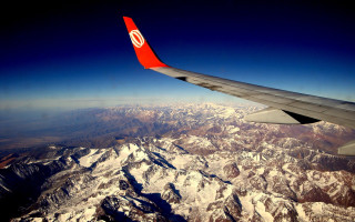 Mountain range airplane window wing - an airplane window free wallpaper