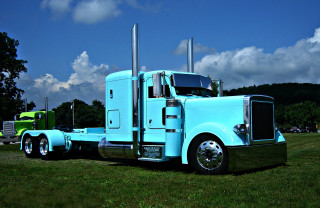 Blue semi truck parked field - a field of grass free wallpaper for desktop