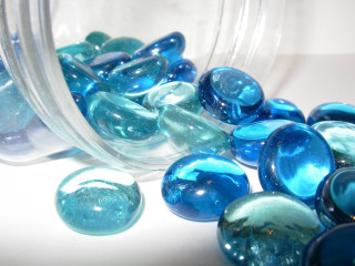 Jar filled blue green marbles - a table next free wallpaper